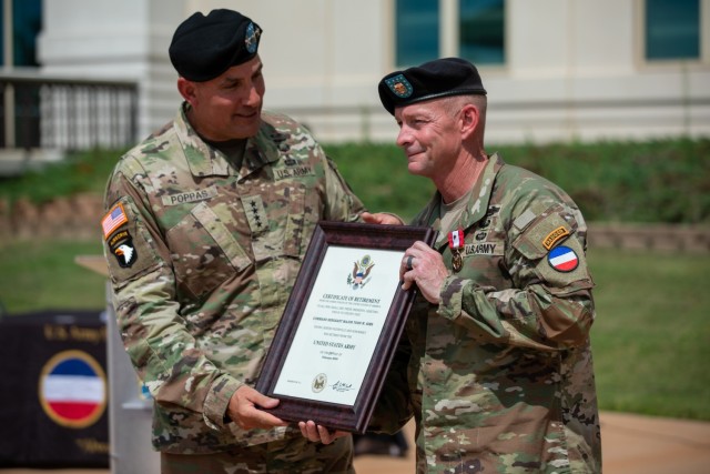 Gen. Andrew Poppas, the commanding general of United States Army Forces Command, presents Command Sgt. Maj. Todd W. Sims, the outgoing command sergeant major of FORSCOM, with the Certificate of Retirement following a change of responsibility...