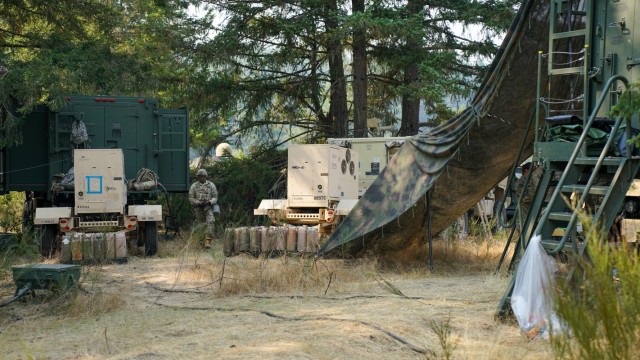 A Soldier from the 1-2 Stryker Brigade Combat Team walks through the Mobile Command Post during a CPI2 Limited User Test on Joint Base Lewis-McChord, Wash., August 21, 2023.