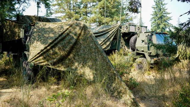 Camouflaged Mobile Command Post vehicles blend in during a CPI2 Limited User Test on Joint Base Lewis-McChord, Wash., August 21, 2023.