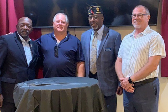 Herman Halmon meets the men who helped return to him a stolen urn containing the remains of his wife, Carolyn Halmon, who died in the Pentagon on Sept. 11, 2001. From left: Herman Halmon, Matt Paul, American Legion administrator Melvin Brown and Lee Nantz.