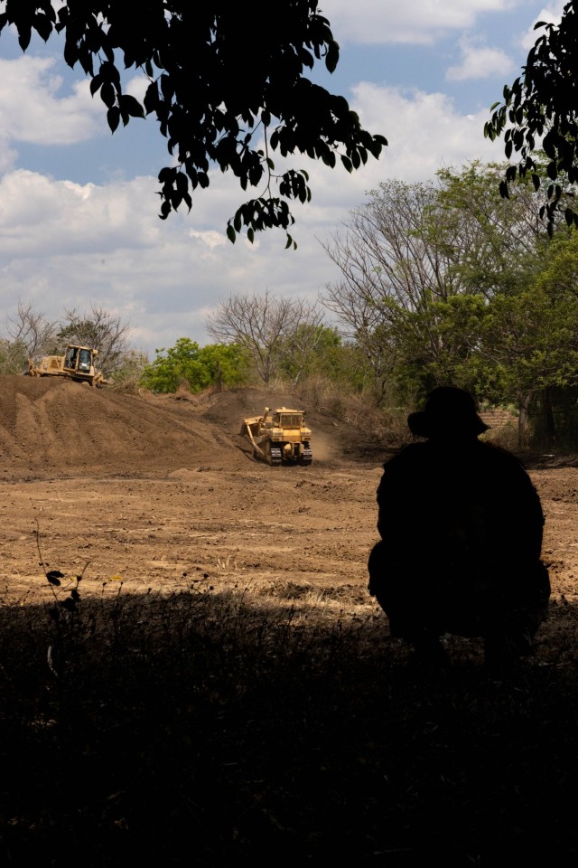 U.S. Army Sgt. Joshua Blas, a heavy equipment operator with the 84th Engineer Battalion, 130th Engineer Brigade, 8th Theater Sustainment Command, supervises soldiers operating dozers to build up a berm on a range during Super Garuda Shield 23 at Puslatpur, Indonesia, Aug. 27, 2023. The U.S. Army 130th Engineers and Indonesian National Armed Forces 2nd Marine Engineer Battalion have been working to raise the range berm 6 feet in order to facilitate multi-lateral training and improve the safety of the range. All service members will qualify on this range before going to live fire exercises during Super Garuda Shield 2023.