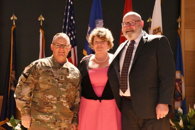 Maj. Gen. Edmond ‘Miles’ Brown (left) joins Mr. Larry Larimer (right) and his wife, Bernadette (center), following the completed Assumption of Responsibility ceremony where Larimer took over as the ne