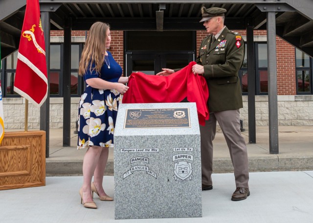 During the Warrior Restaurant dedication ceremony for Bldg. 6111 Monday, Katie Celiz and Col. Joseph Goetz, U.S. Army Engineer School commandant, unveil a granite monument. The building is renamed for Sgt. 1st Class Christopher Celiz — a combat engineer killed in 2018, while serving in Afghanistan. 