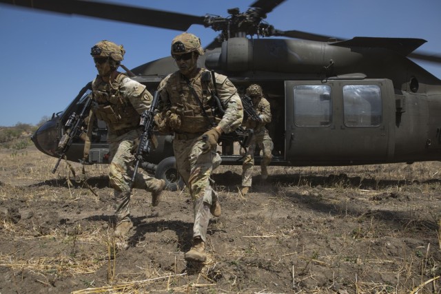 U.S. Army Soldiers assigned to B company, 1st Battalion, 27th Infantry Regiment, 25th Infantry Division, exit a UH-60 Black Hawk to assault an objective during the combined arms live fire exercise while supporting Super Garuda Shield 2023, at 5th Marine Training Center (Puslatpur), Situbono Regency, East Java, Indonesia, Sept. 11, 2023.