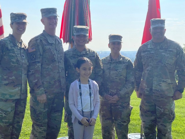 Staff Sgt. Kaileen Santos, center, and her daughter pose for a photo with Army Director of Staff Lt. Gen. Walter Piatt, second from left, and his staff. 