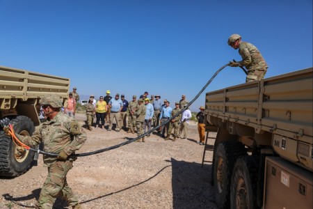 Two U.S. Army soldiers assigned to Alpha Battery, 2nd Air Defense Artillery Regiment, 1st Battalion, 43rd Air Defense Artillery Regiment, 11th Air Defense Artillery Brigade participate in a training exercise, Aug. 31, at McGregor Range, New Mexico. The training was to showcase the practical implementation of tactical microgrid standard equipment.
