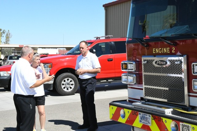 Lake Martinez Fire Department Fire Chief Jodi Little (center) listens to Yuma Proving Ground Fire Department Fire Chief Gerald Ball (left) and Assistant Fire Chief Matt Kelly (right) during a recent tour of YPG&#39;s Fire Station #2.