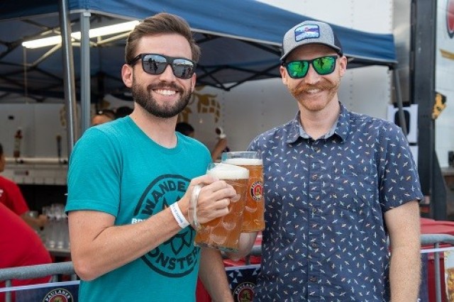 Alex Carney and Brandon Adams have a beer at Oktoberfest. 