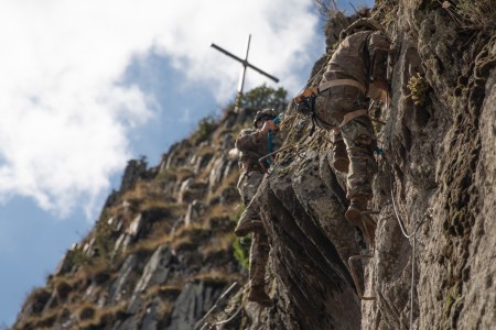 Soldiers with the 1st Battalion, 87th Infantry Regiment, 1st Brigade Combat Team, 10th Mountain Division (LI) conduct the via ferrata station, which involves traversing across a slope with the help of cables and rungs, during a mountain movement technique training course involving high-angle terrain in the Rhodope Mountains on Sep. 18, 2023, near Smolyan, Bulgaria, during Combined Training Exercise Rhodope 23.