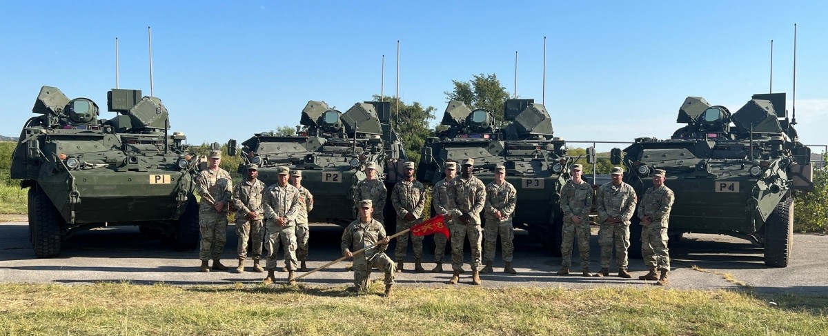 Soldiers of the 4th Battalion, 60th Air Defense Artillery Regiment are positioned alongside four Directed Energy Maneuver-Short Range Air Defense (DE M-SHORAD) prototype systems.