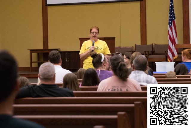 Renee Foley, Awana Club commander, speaks to children and parents on the first night of Community Connections Sept. 7. The Awana Club is in need of volunteers. For more information on how to volunteer scan the QR code pictured above. (U.S. Army...