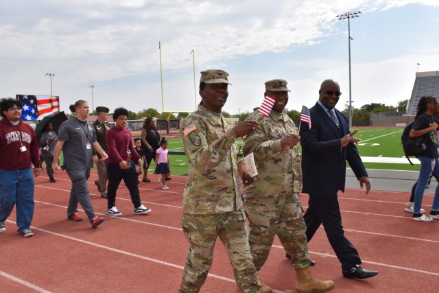 Steven Moore, Fort Cavazos Community Relations chief, joins Col. Lakicia Stokes, U.S. Army Garrison-Fort Cavazos commander, and Command Sgt. Maj. Calvin Hall, U.S. Army Garrison-Fort Cavazos command sergeant major, during the Freedom Walk Monday at Leo Buckley Stadium. (U.S. Army photo by Janecze Wright, Fort Cavazos Public Affairs)