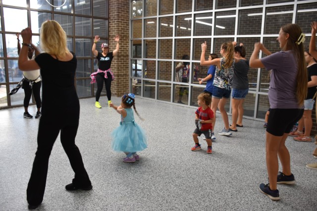 Ladies Zumba Fort Cavazos got hearts pumping and feet moving with a Zumba Fitness demonstration during the Resiliency Fun Fair Saturday at the Apache Arts & Crafts Center. (U.S. Army photo by Janecze Wright, Fort Cavazos Public Affairs)