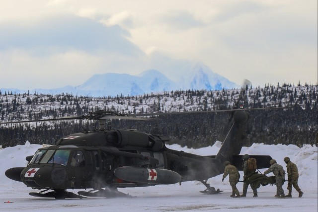 Soldiers assigned to Charlie Co., 1-52 General Support Aviation Battalion, conduct a MEDEVAC rehearsal near Fort Greely, Alaska, March 8, 2022.