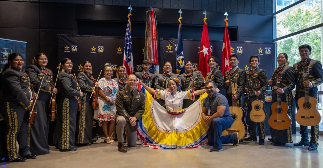 AFC personnel Lt. Gen. D. Scott McKean, left of center, and Lt. Col. Carolina Cruz, center, pose with members of the Harlandale High School Mariachi Band of San Antonio, Texas.