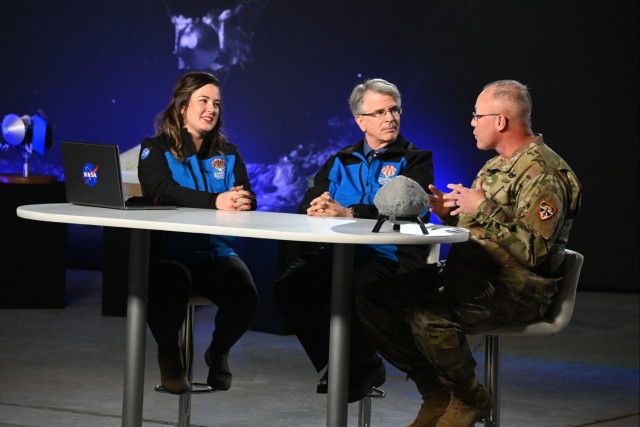 U.S. Army Dugway Proving Ground commander Col. James Harwell (right) appears on a live broadcast of the NASA Channel with hosts Lauren Ward and NASA Chief Scientist Jim Garvin minutes after the landing of a sample of the asteroid Bennu at the Utah...