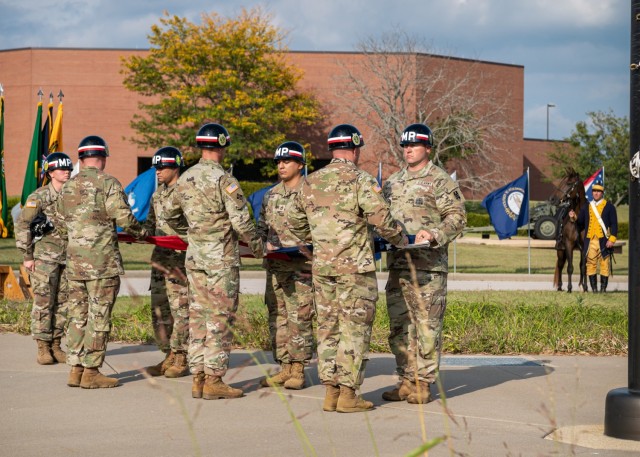 Military Police Soldiers fold the U.S. flag during a Retreat ceremony Sept. 20 on the Maneuver Support Center of Excellence Plaza, as part of MP Regimental Week.