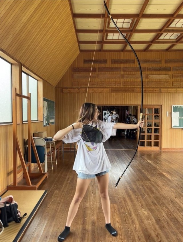Carr using a traditional Japanese bow at the archery club