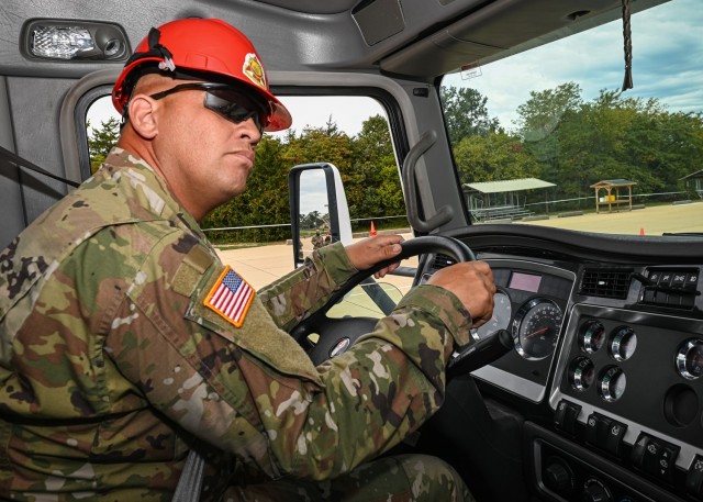 Sgt. 1st Class Ernest Haefner, from the 58th Transportation Battalion, checks the mirrors of the Air Force’s sleeper cab tractor trailer during the Joint Service Truck Rodeo competition Friday at Training Area 228. Haefner was awarded for...