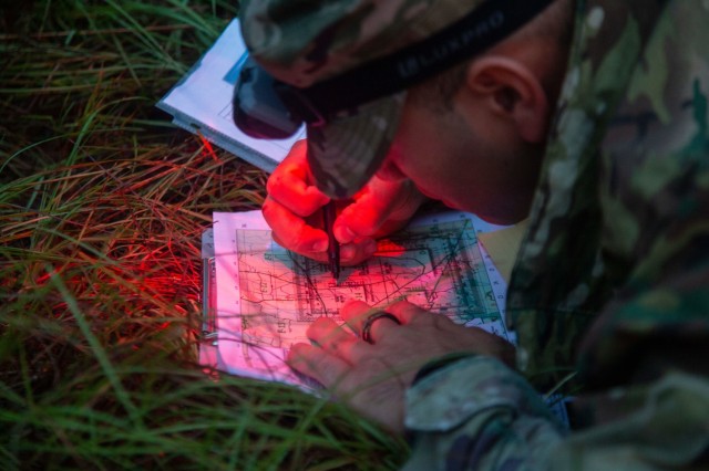 A U.S. Army Soldier participating in the 2023 Best Squad Competiton draws coordinates during the night land navigation event, on Fort Stewart, Georgia, Sept. 26. 2023. Each Soldier&#39;s individual readiness is vital to the effectiveness of the squad and readiness of the Army as a whole. An important element in maintaining that edge is physical readiness — maintaining the level of fitness required to effectively perform your duties as a Soldier and a member of a team. 