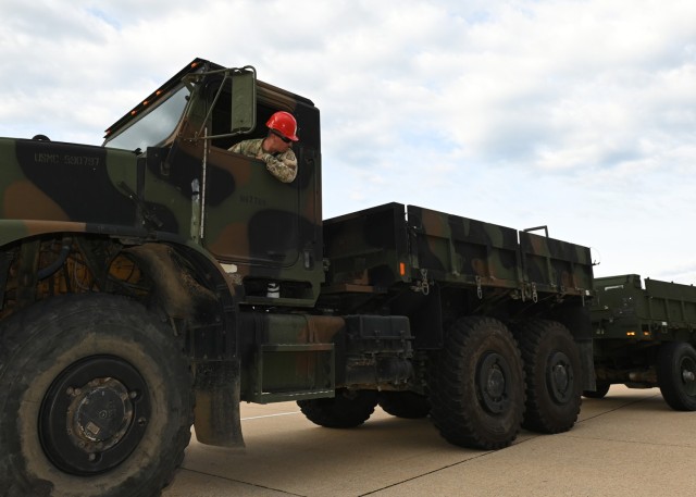 Staff Sgt. Armando Trujillo, from the 58th Transportation Battalion, drives the Marine Corps’ Medium Tactical Vehicle Replacement with a MK593 cargo trailer through a question mark-shaped alley during the Joint Service Truck Rodeo Friday at...