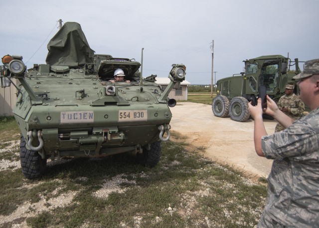 Air Force Junior ROTC cadets Devin Burnett (in vehicle) and Sean Nichols, from St. Clair High School in St. Clair, Missouri, take the opportunity to get photos at Training Area 244 Saturday during their visit to Fort Leonard Wood.