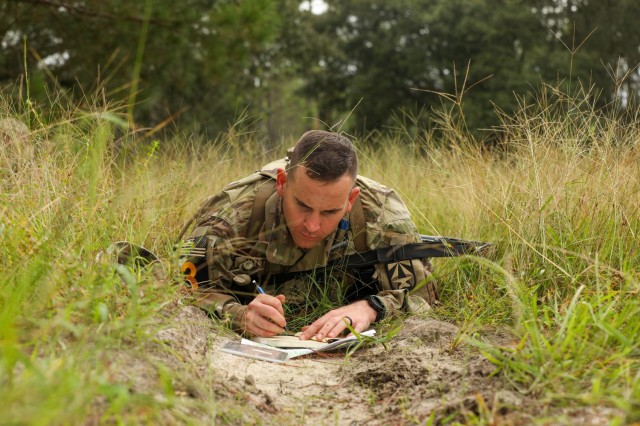 Staff Sgt. Jesse Hylton, a native of Interlachen, Florida representing Army Futures Command, plots coordinates during the land navigation portion of the 2023 Army Best Squad Competition at Fort Stewart, Georgia, Sept. 26, 2023. The Soldiers competing for Best Squad are composed of teams from various units and military occupational specialties from across the Army.