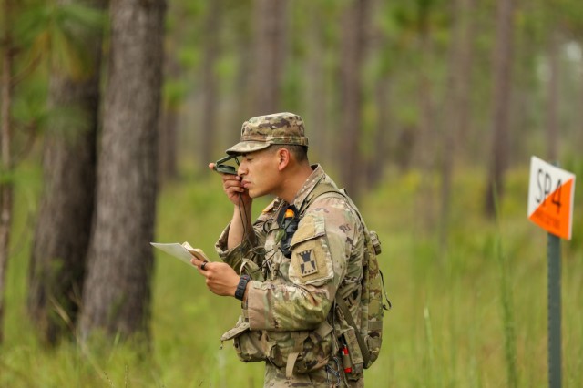 Spc. Hayse Jorgensen, a native of Mason City, Iowa representing the Military District of Washington, looks through his compass during the land navigation portion of the 2023 Army Best Squad Competition at Fort Stewart, Georgia, Sept. 26, 2023. The competition tests the squad’s proficiency in their warrior tasks and battle drills and identifies the most cohesive, highly trained, disciplined and fit team that is ready to fight and win — while demonstrating commitment to the Army Values and Warrior Ethos.