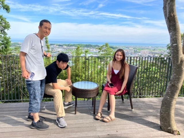 Carr and her host brother and host father at a cafe