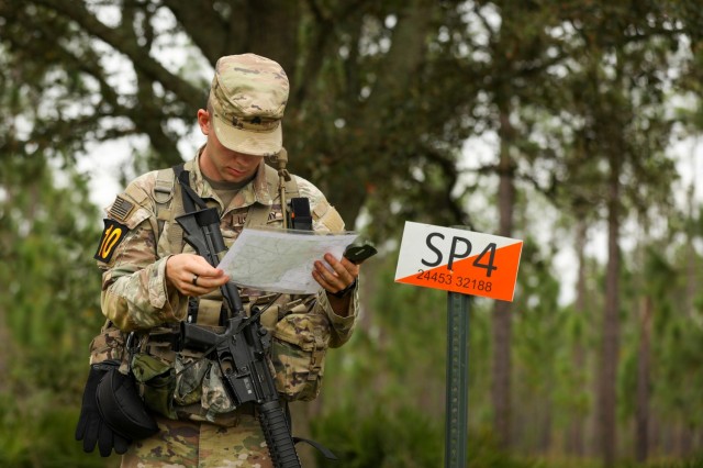 Sgt. Toby Jones, a native of San Diego representing U.S. Army Cyber Command, checks his map before starting the 2023 Army Best Squad Competition at Fort Stewart, Georgia, Sept. 26, 2023. During Best Squad Competition, squads complete a fitness assessment, 12-mile foot march, weapons proficiency, and hands-on Squad tasks.