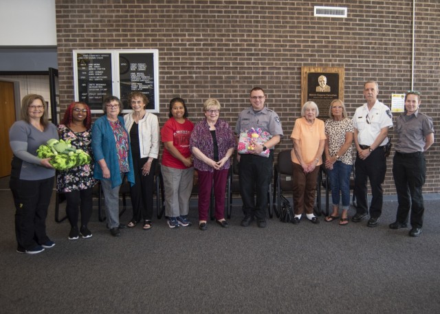 Installation first responders and hospital staff pose for a photo Sept. 21 in the Army Community Service lobby with volunteers from Fort Leonard Wood’s Retiree Survivor Support Group, who donated no-sew fleece blankets and stuffed toys for...