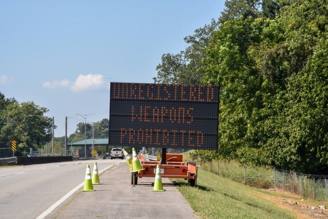 Signs outside the Redstone gates remind commuters that weapons on post must be registered.  
