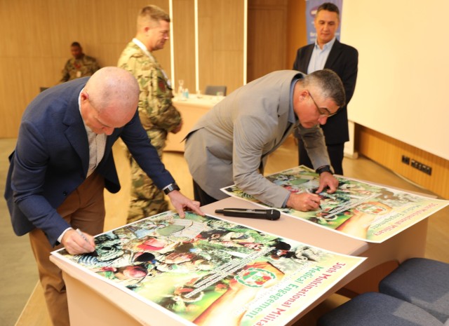 Brig, Gen. Clinton Murray and Command Sgt. Maj. Jesus Gonzalez sign certificates commemorating the 30th Annual Multinational Military Medical Engagement held in Budapest, Hungary Sept. 26-28 2023.