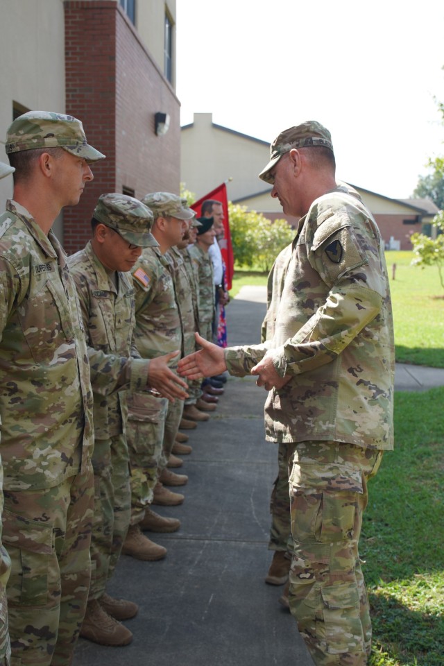 USASAC&#39;s Command Sgt. Maj. Stephen Burnley congratulates SATMO personnel during a coin ceremony at Fort Liberty, N.C. in September 2023.        