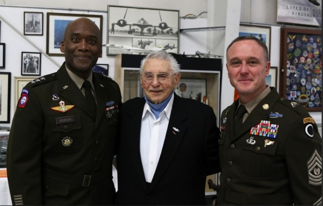 Lt. Gen. Xavier Brunson (left), America’s First Corps commanding general, retired Tec. 5 Harvey Drahos and Command Sgt. Maj. Shawn Carns, America’s First Corps command sergeant major, celebrate Drahos earning his Purple Heart Medal in Olympia...