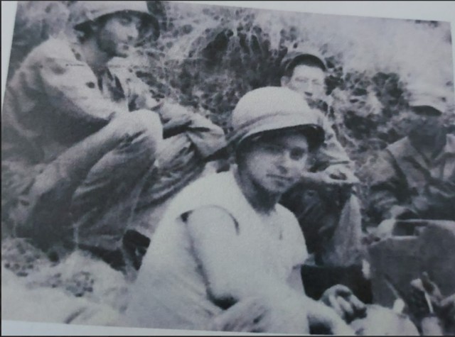 Retired Tec. 5 Harvey Drahos and members of his unit.