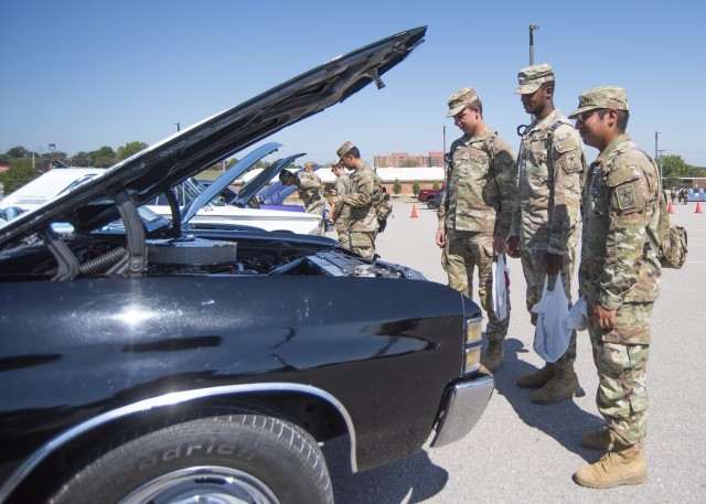 Trainees with the 58th Transportation Battalion look at the car show entries during Fire Fest Saturday in the Exchange parking lot. The annual celebration – held each year around Fire Prevention Week, provides an opportunity for area...