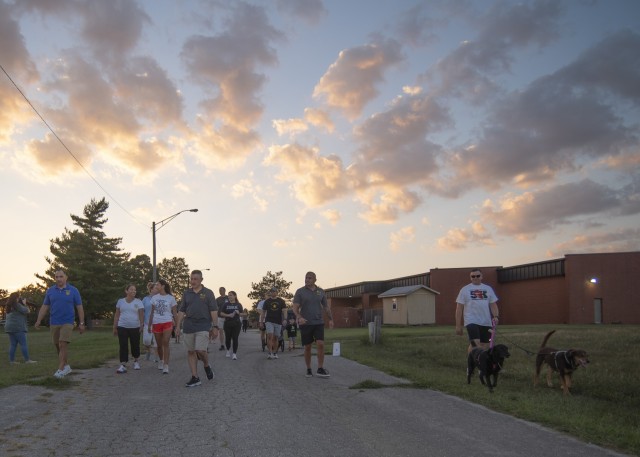 Family members of fallen service members, alongside Fort Leonard Wood senior leaders, begin a two-mile twilight walk Saturday from the USO to Memorial Grove and back during a survivor family remembrance event hosted by the installation’s...