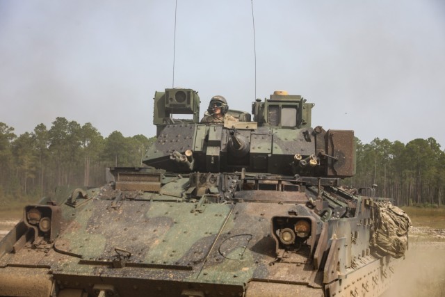 A Bradley Fighting Vehicle arrives to load Soldiers participating in the situational training exercise portion of the Army Best Squad Competition at Fort Stewart, Georgia, Oct. 3, 2023. Squads conduct a fitness assessment, 12-mile foot march, weapons proficiency test, hands-on squad tasks, written exam and essay, and culminates with a board interview with sergeants major from across the Army.