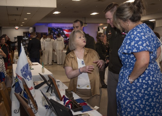 Teresa Cleaver, mother of Staff Sgt. John Cleaver, who passed away in 2009, speaks with Maj. Gen. Christopher Beck, Maneuver Support Center of Excellence and Fort Leonard Wood commanding general, and his wife, Sally, during a survivor family...