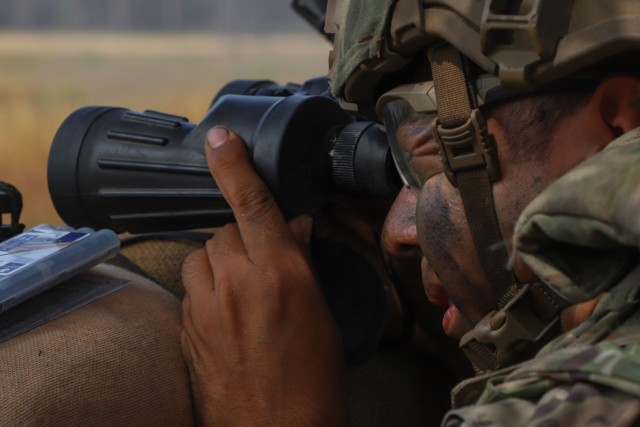 A competitor uses binoculars for a static shoot event during the Army Best Squad Competition at Fort Stewart, Georgia, Oct. 3, 2023. The Army is a people-based institution and individual Soldier readiness is the foundation of Army Readiness. The...