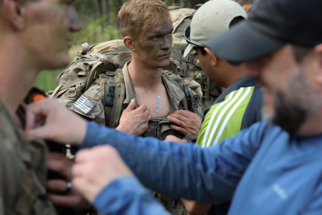Sgt. Jake Phillips, a native of West Chester, Pennsylvania, representing U.S. Army Special Operations Command, has a vital sign monitoring device fitted to his chest during a situational training exercise of the Army Best Squad Competition at Fort Stewart, Georgia, Oct. 3, 2023. Vital sign monitoring devices help keep the competitors safe during all parts of the competition and are worn at all times.