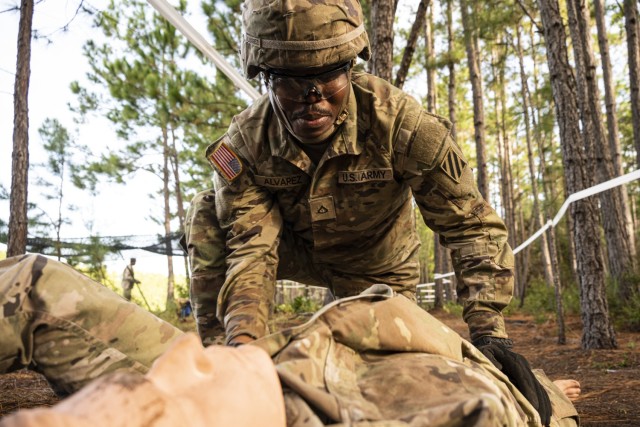U.S. Army Pfc. Delroy Alvarez, a combat medic with Company C, 3rd Brigade Support Battalion and native of Los Angeles, demonstrates casualty evaluation as part of the 2023 Army Best Squad Competition at Fort Stewart, Georgia, Sept. 29, 2023. A development team with the U.S. Army Medical Materiel Development Activity (USAMMDA) is attending the competition to assess the real-world applicability of the Health Readiness and Performance System (HRAPS) during training and operations. HRAPS is a wearable device to help frontline medical providers and commanders monitor service members’ physiological responses to rigorous activities during both training and combat. Once fielded, HRAPS may help reduce the risk of non-battle injuries, including heatstroke and overexertion, by providing near-real-time physiological data to help leaders recognize serious medical conditions needing immediate treatment before they become critical. USAMMDA, the DoD’s premier developer of world-class military medical capabilities, develops, delivers, and fields critical drugs, vaccines, biologics, devices, and medical support equipment to protect and preserve the lives of Warfighters across the globe.