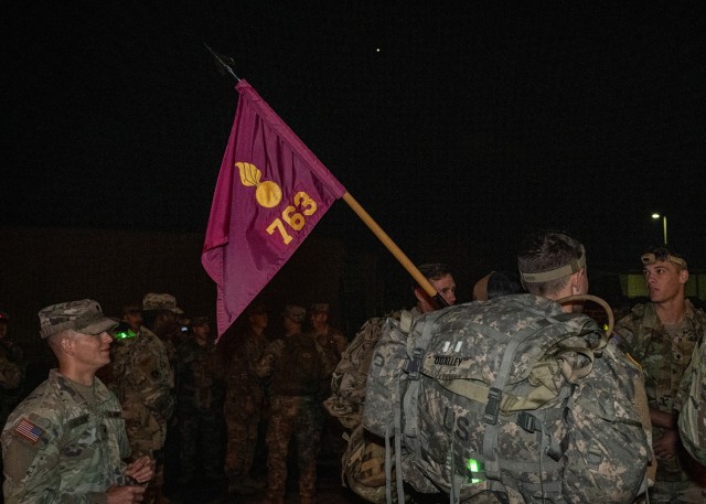Soldiers get ready for a ruck march in memory of Sgt. Maj. Kenneth Foster Sept. 28 outside the 763rd Ordnance Disposal Company (EOD) headquarters building.