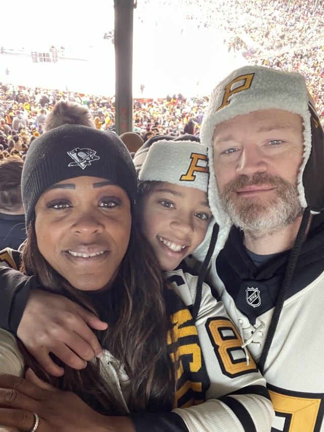 Col. Tasha Lowery, joint base commander, left, enjoys a January 2023 Pittsburgh Penguins game with her son, Shawn, Jr., and husband, Shawn Lowery, Sr. 