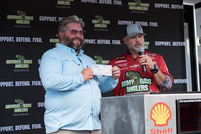 Brad Luis, a Navy and Army veteran, receives a check for $2,500 for catching the largest fish of all the non-boaters Sept. 23 during Fishing for Freedom. Luis brought in a 4.10-pound largemouth bass during the third weigh in period. “I’m super...