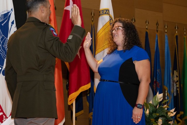 Commanding General of U.S. Army Communications-Electronics Command and Aberdeen Proving Ground Senior Commander Maj. Gen. Robert L. Edmonson II administers the oath of office at the promotion ceremony of Ms. Nicole Osaghae on 4 October 2023.