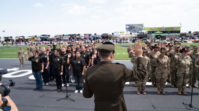 Lt. Gen. Sean C. Bernabe, III Armored Corps and Fort Cavazos commanding general, gives the oath of enlistment to 25 future Soldiers and to 25 additional Soldiers who will remain on active duty in front of an audience of thousands Sept. 24 at Texas Motor Speedway during the Autotrader Echo Park Automotive 400 series race. (U.S. Army photo by Eric Franklin, Fort Cavazos Public Affairs) 