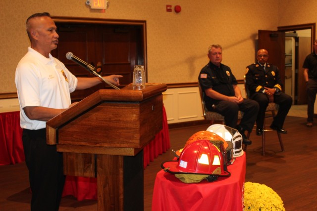 Redstone Fire Chief Ragnar Opiniano praises retiring Driver/firefighter Terry Asherbranner and Assistant Chief Sam Ivy.
