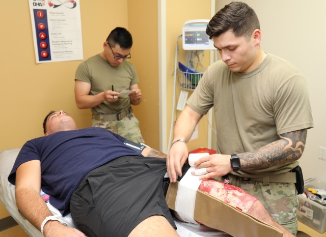 Sgt. Erick Menendez, right, who is assigned to U.S. Army Medical Department Activity–Japan, treats a volunteer with a mock leg injury during a mass casualty exercise inside the BG Sams U.S. Army Health Clinic at Camp Zama, Japan, Oct. 5, 2023....